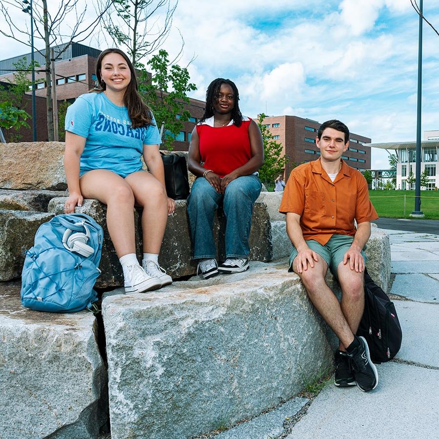 quad students sitting on cinder blocks in quad