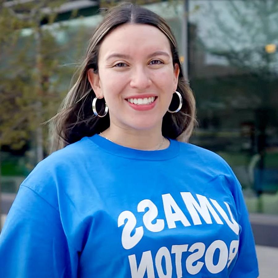 UMass Boston student Olivia smiles by the residence halls